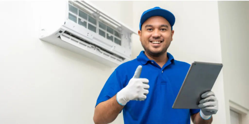 Technician giving a thumbs up sign while holding an iPad